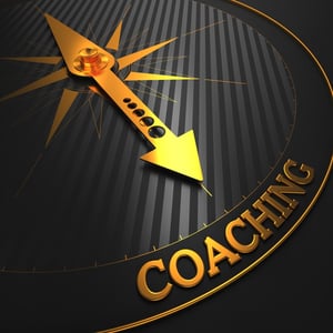 Coaching - Business Background. Golden Compass Needle on a Black Field Pointing to the Word "Coaching". 3D Render.