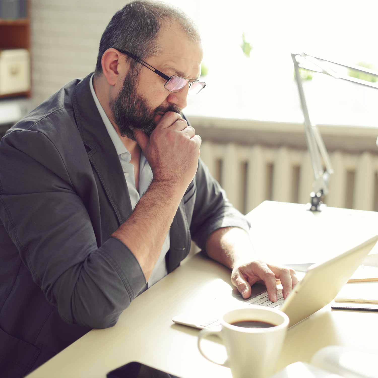 pensive_man_looking_at_laptop